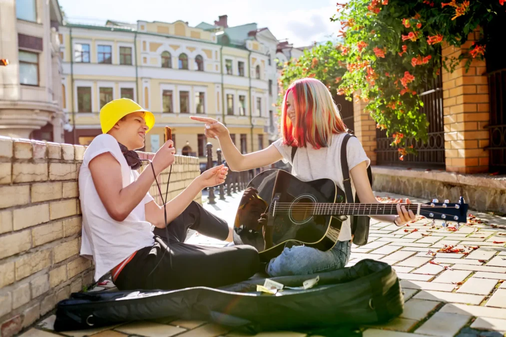 Musicians on street collecting tips.